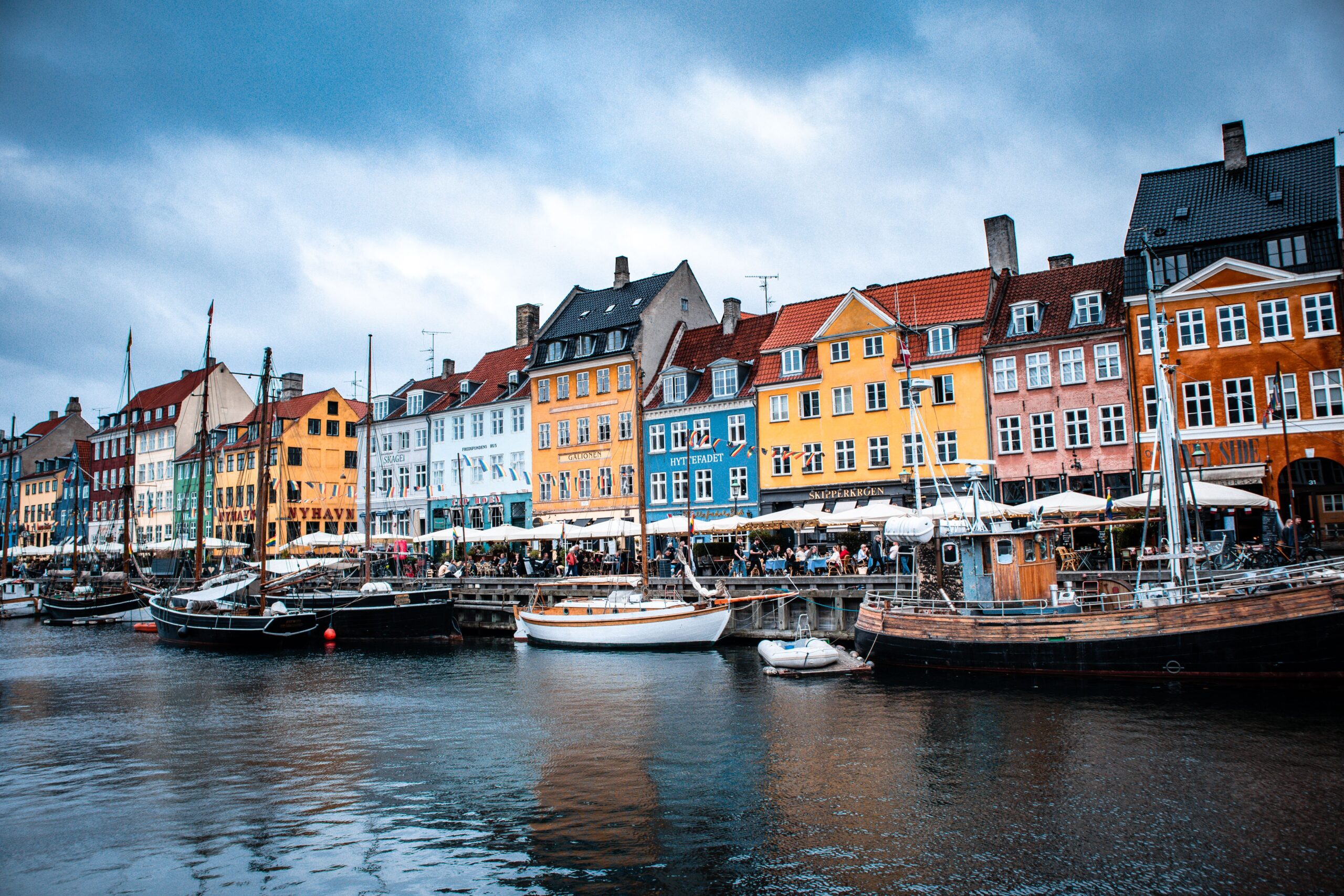 Vibrant boats and colorful buildings at Nyhavn harbor, Copenhagen's iconic waterfront.