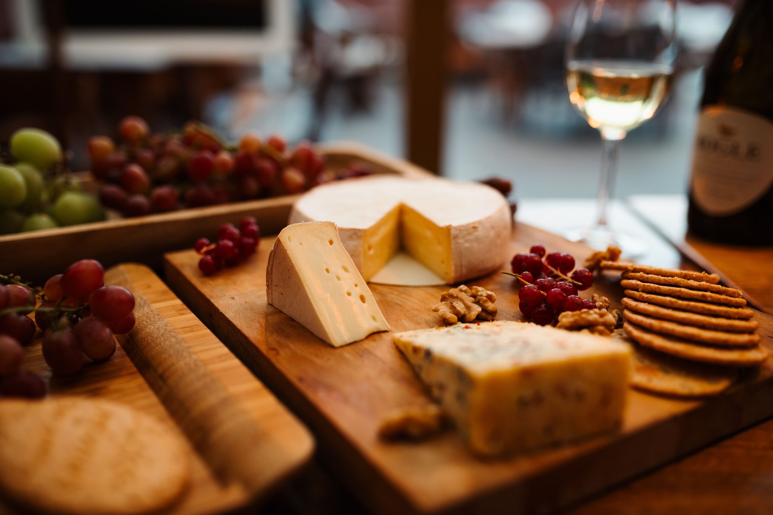 Savor an elegant cheese board with wine, grapes, and nuts in Liseleje, Denmark.