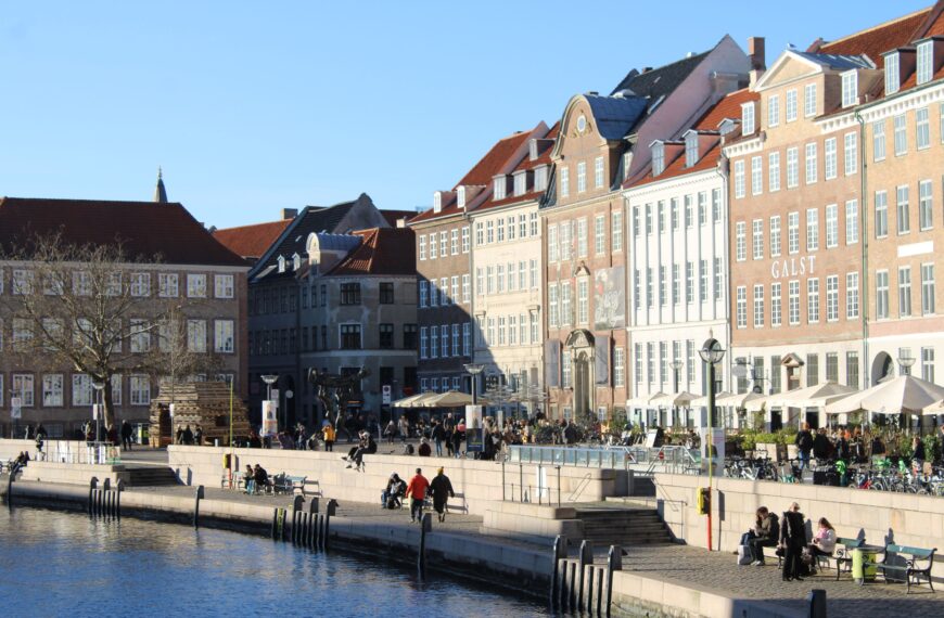 A sunny winter day along Copenhagen's waterfront, showcasing historic architecture.