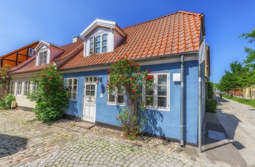 Colorful traditional house in Århus, Denmark, showcasing vibrant architecture and cobblestone streets.