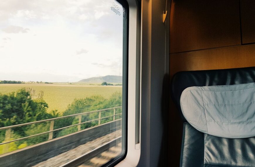 Captivating view of the countryside from a train window during daylight.