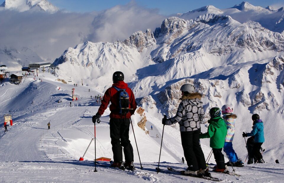 a group of people riding skis on top of a snow covered slope