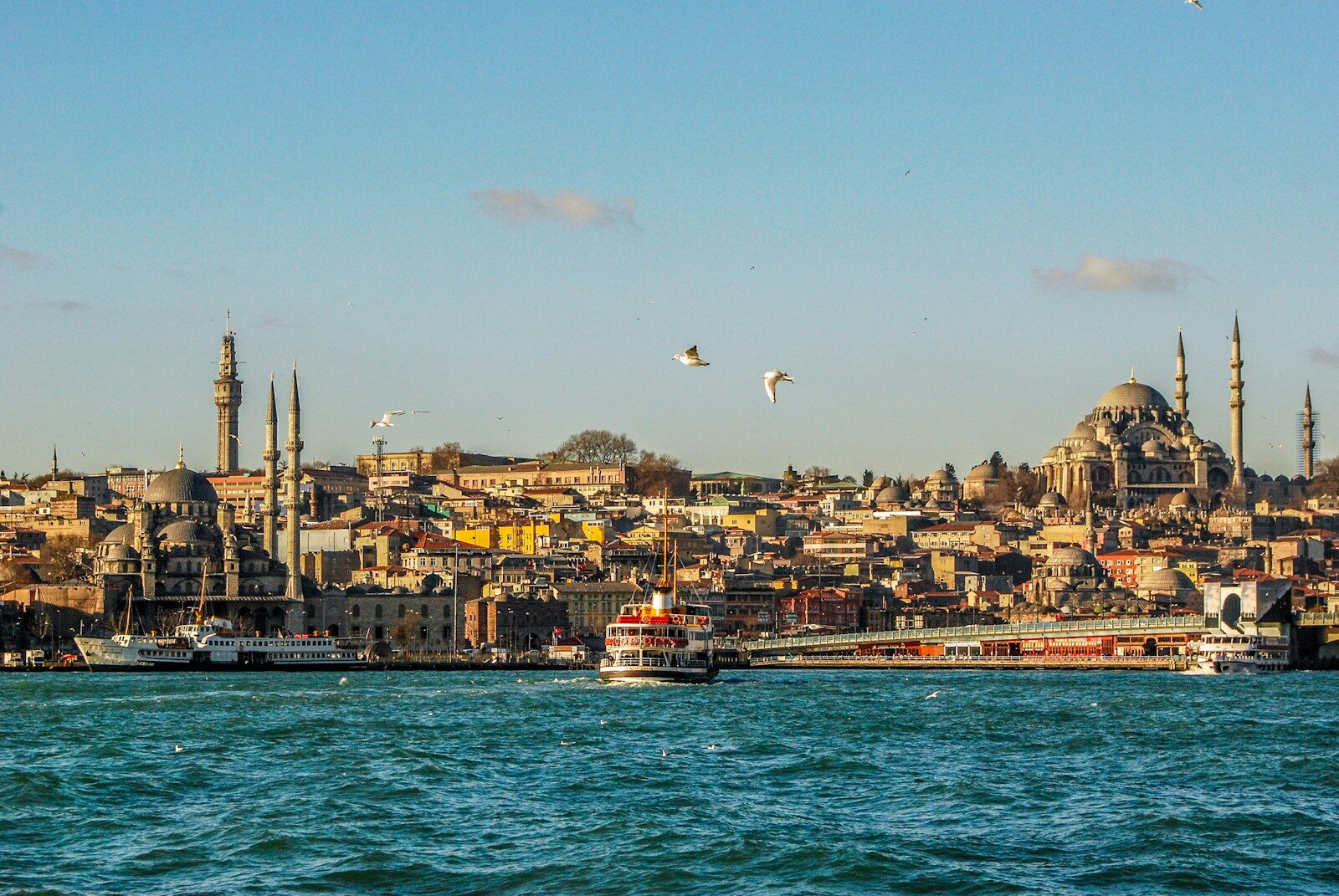 A ferry crossing the Bosphorus with the skyline of Eminönü, Istanbul, in the background