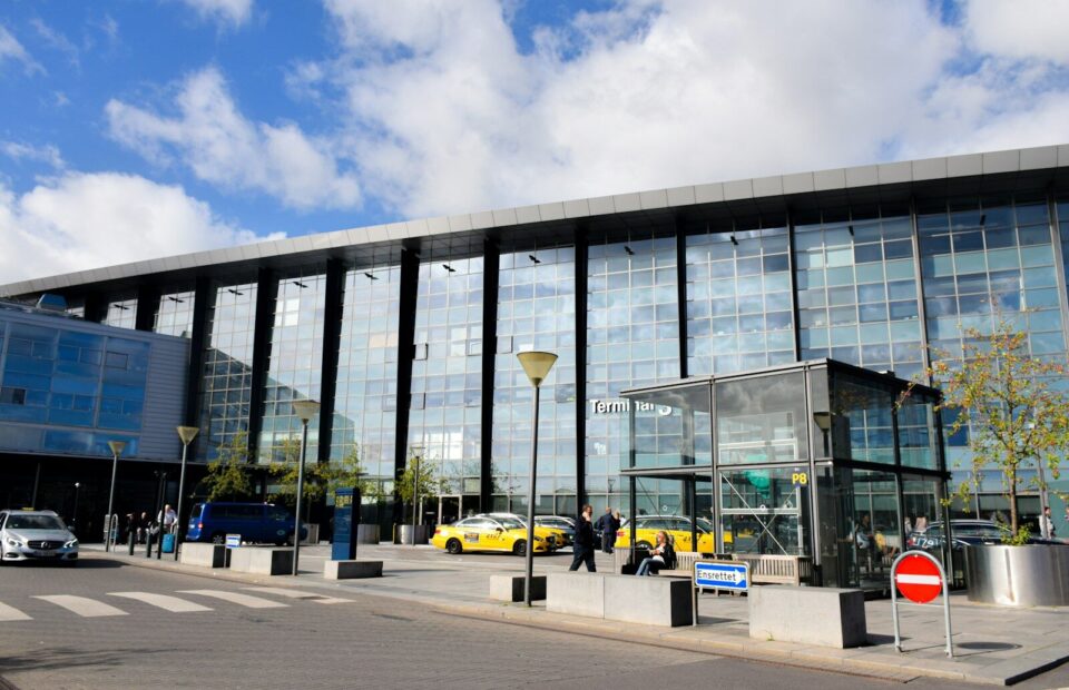 Terminalbygning med glasfacade og taxier ved Københavns Lufthavn